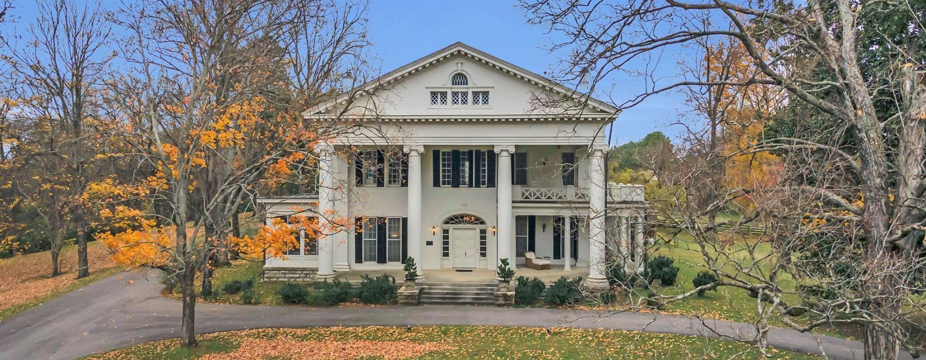 a white house with columns and a driveway